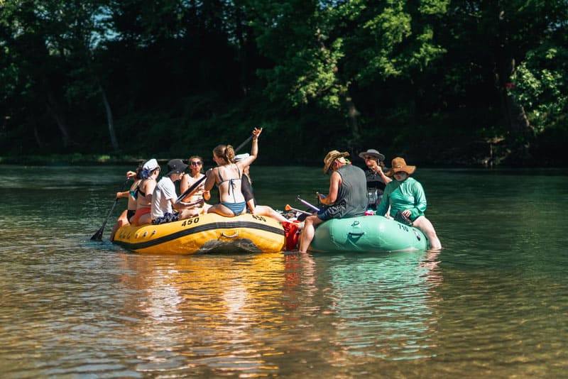 two groups of friends raft side by side on the Elk River, River Ranch Resort Noel, Missouri