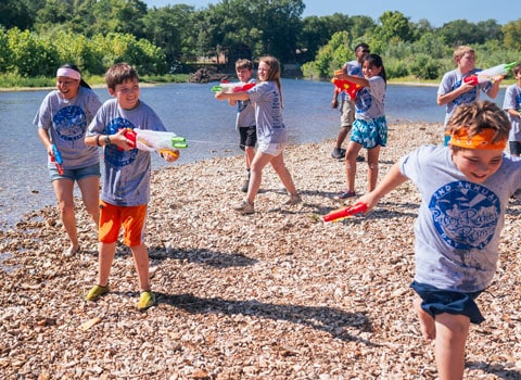 children attending camp at River Ranch Resort Noel, Missouri have fun playing along the water