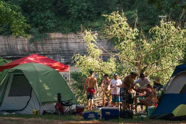 group of campers have their tents set up along the Elk River at River Ranch Resort Noel, Missouri
