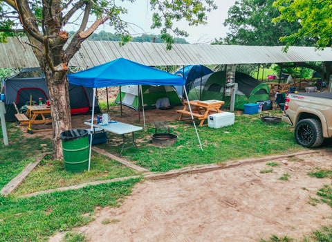several campers set up tents at shelter campsite near River Ranch Resort in Noel, Missouri