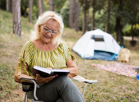 woman on church retreat reads Bible during a church camping retreat River Ranch Resort Noel, Missouri
