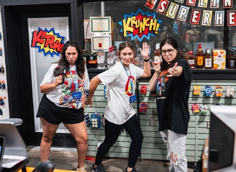 three female employees of River Ranch Resort Noel, Missouri pose as superheroes