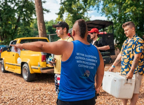 employee of River Ranch Resort Noel, Missouri directs campers where to set up their site
