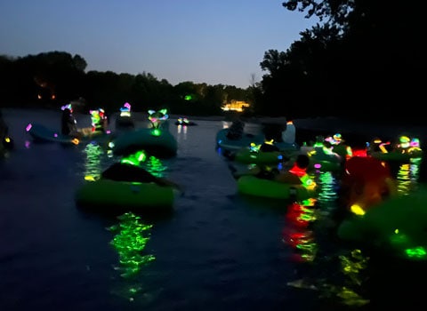 glowing colors seen on the river during the glow float at night River Ranch Resort Noel, Missouri