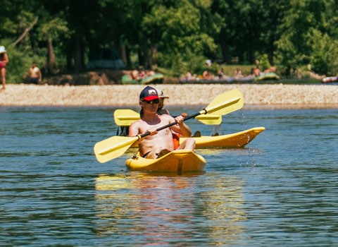 guests paddle in kayaks while others stay on shore River Ranch Resort Noel, Missouri