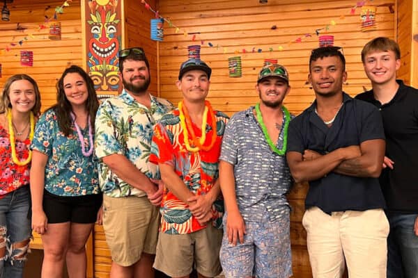 employees dress in Hawaiian theme and pose for a photo River Ranch Resort Noel, Missouri