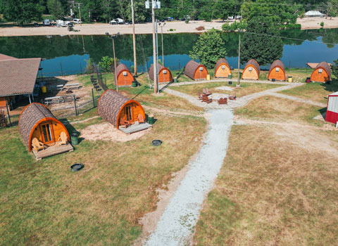 camping pods and common area along the Elk River at River Ranch Resort Noel, Missouri