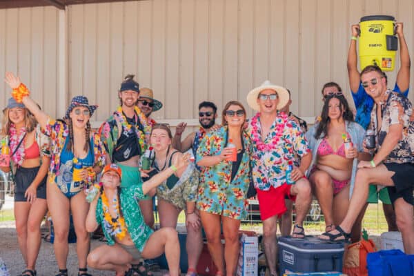 guests at River Ranch Resort Noel, Missouri pose for a photo during an Hawaiian themed party