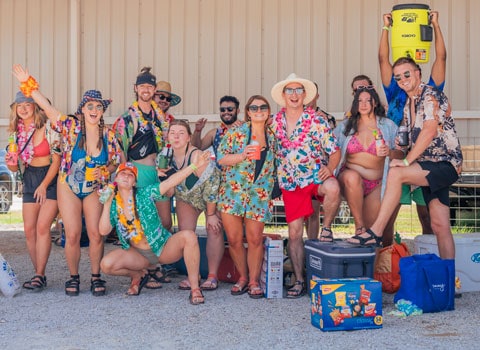 guests at River Ranch Resort Noel, Missouri pose for a photo during an Hawaiian themed party