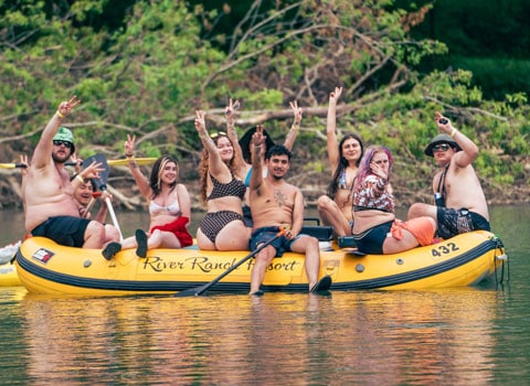large group of rafters show the peace sign as the pose for a photo River Ranch Resort Noel, Missouri