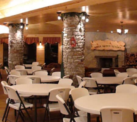 large room with tables and chairs located at River Ranch Resort Noel, Missouri