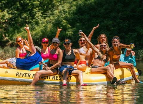 group of happy rafters pose for a photo during their Elk River float with River Ranch Resort Noel, Missouri