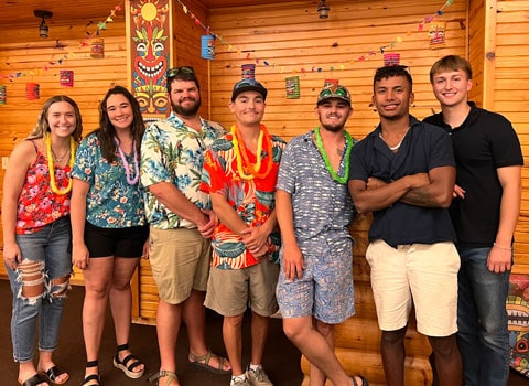 employees for River Ranch Resort Noel, Missouri pose for a photo during an Hawaiian themed party