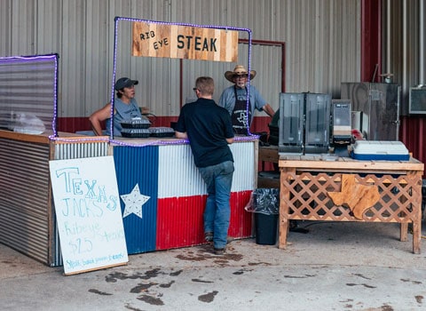 male customer purchases to go order from Texas Jacks steaks at River Ranch Resort Noel, Missouri