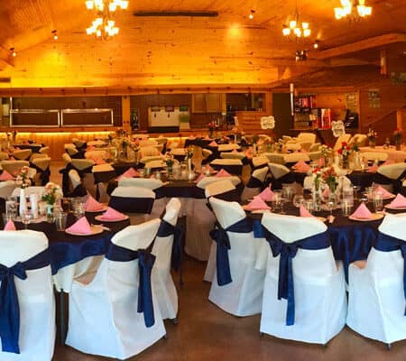 white covers with blue ribbon cover chairs for a wedding decor River Ranch Resort Noel, Missouri